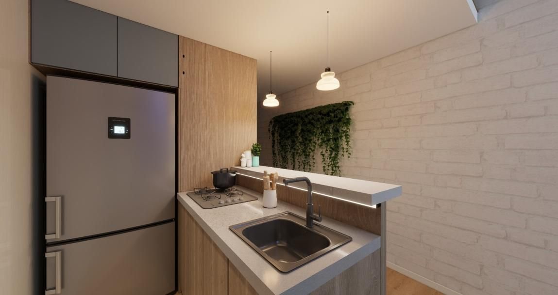 Zona de cocina con mesón y lámparas, imagen de referencia